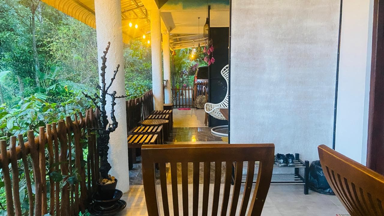 Covered Hidden Cove balcony with wooden seating along the jungle railing