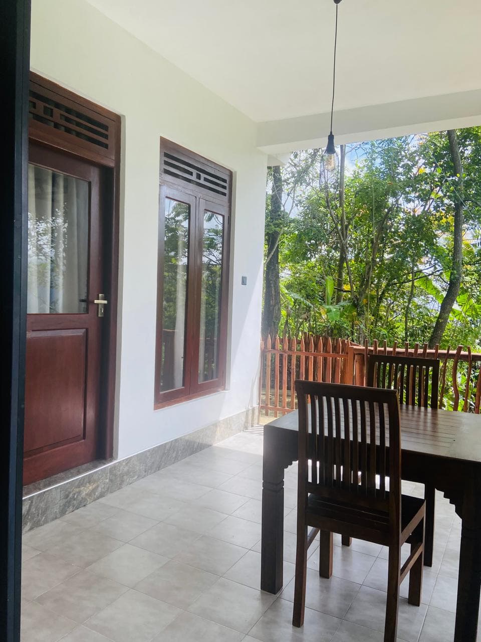 Hidden Cove balcony with dining table facing the jungle