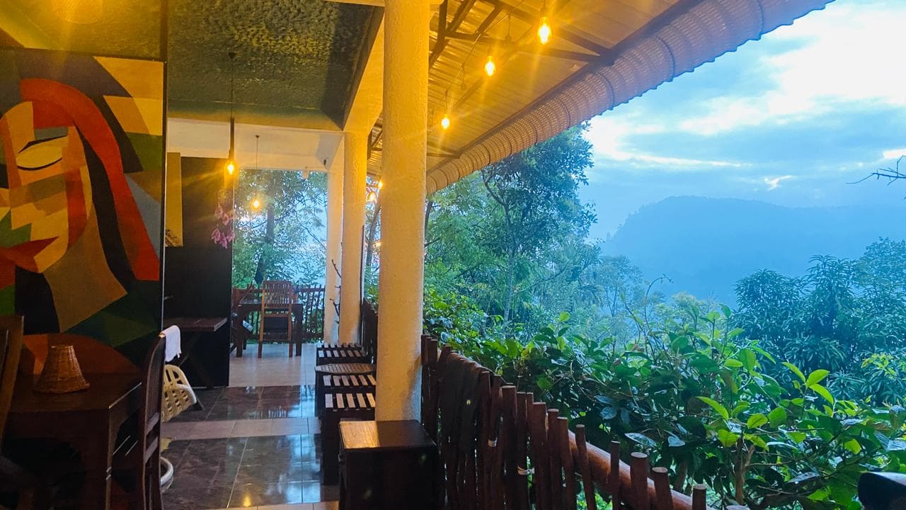 Covered Hidden Heaven balcony looking toward misty hills at dusk