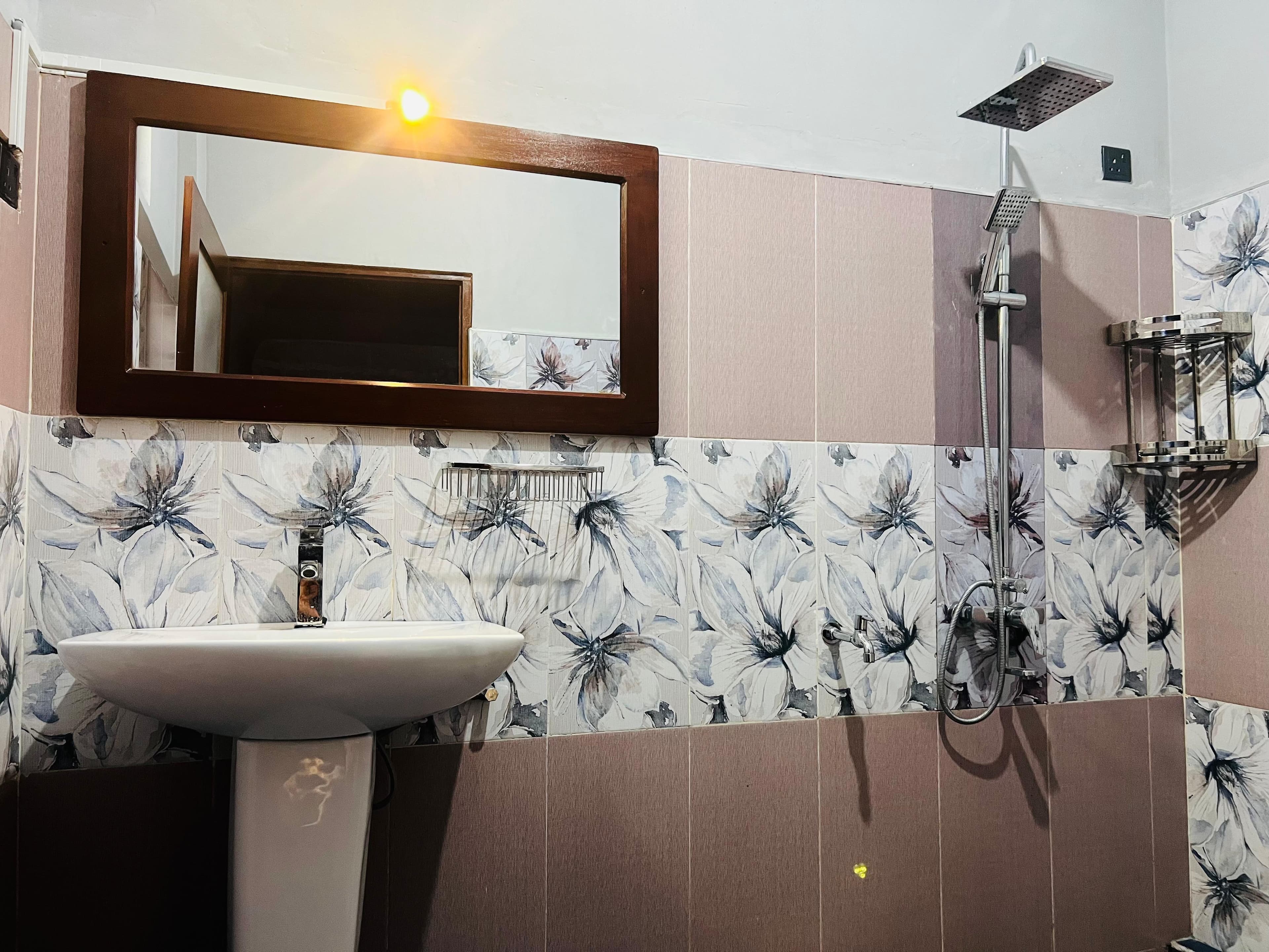 En-suite bathroom with rain shower and vanity mirror